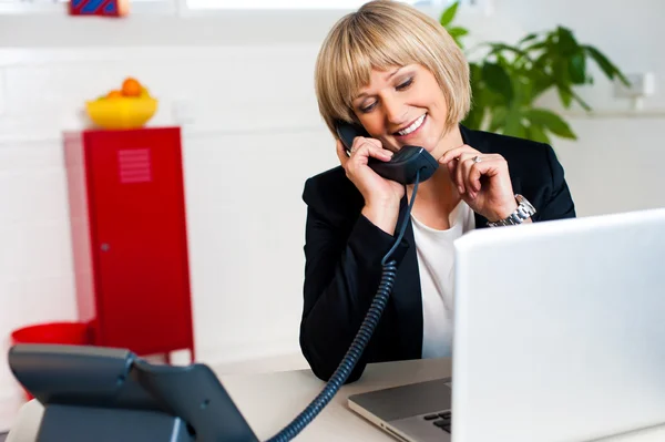 Secretary attending call before passing it to boss — Stock Photo, Image