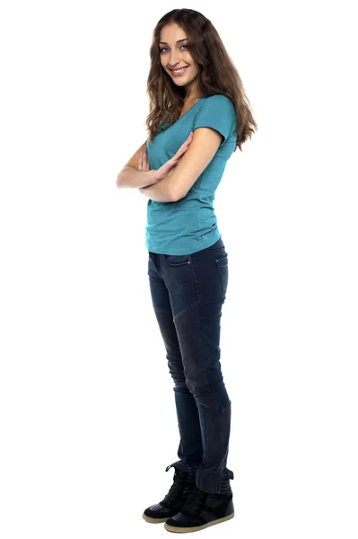 Stylish woman standing sideways with arms crossed — Stock Photo, Image