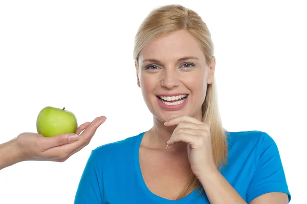 Attractive woman is being offered a green apple — Stock Photo, Image
