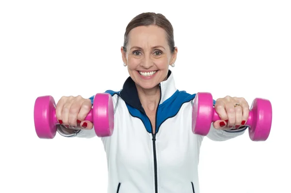 Mujer haciendo ejercicio con pesas rosadas — Foto de Stock