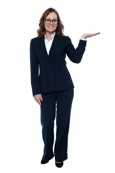 Woman in business attire posing with an open palm — Stock Photo, Image