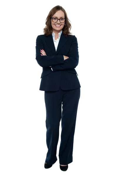 Executive in business attire standing arms folded — Stock Photo, Image
