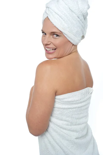Hot woman in bath towel turning back towards camera Stock Photo