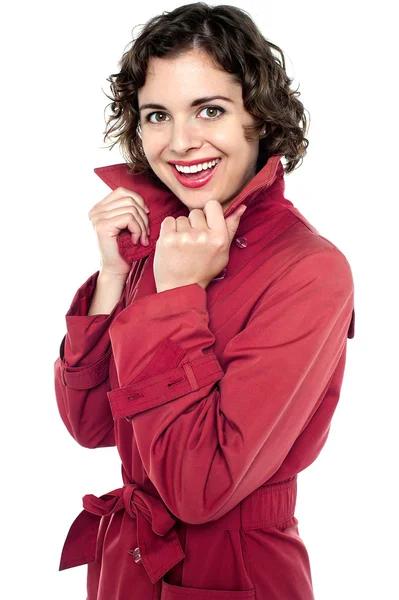 Γυναίκα όμορφη μόδας που ποζάρει με ένα κόκκινο παλτό — Φωτογραφία Αρχείου