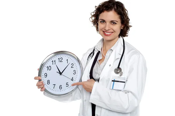 Doctor holding a clock — Stock Photo, Image