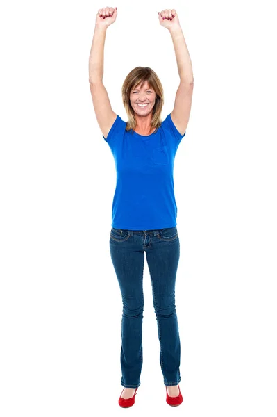 Excited woman in celebration mood with raised arms — Stock Photo, Image