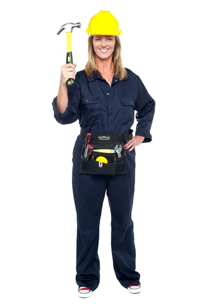 Smiling constrution worker displaying hammer — Stock Photo, Image