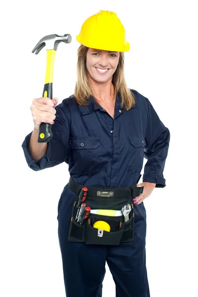 Smiling constrution worker displaying hammer — Stock Photo, Image