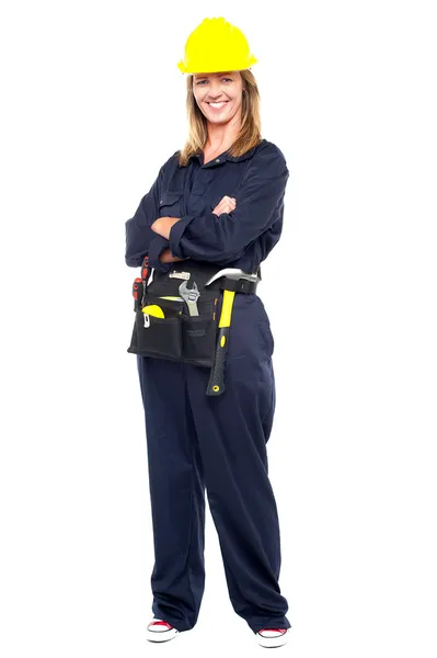 Confident woman with helmet and belt of tools — Stock Photo, Image