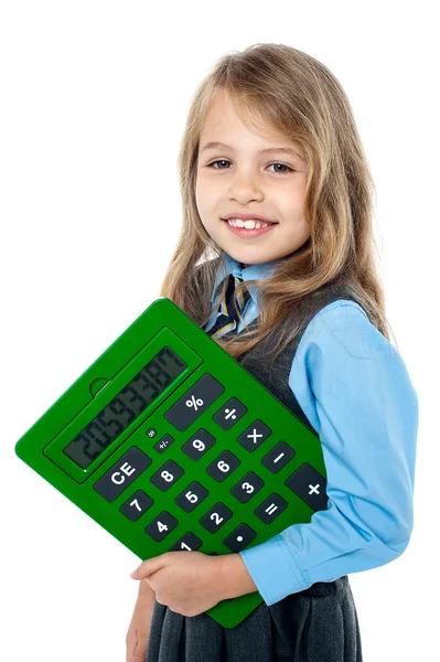 Cheerful kid holding big green calculator Royalty Free Stock Photos