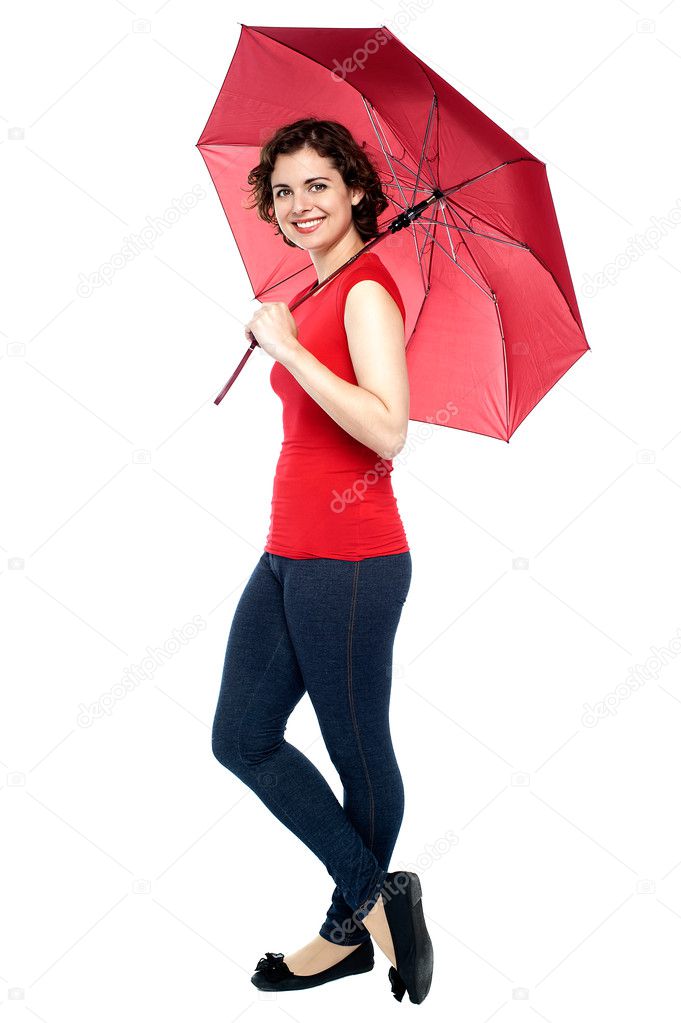 Young woman posing under umbrella