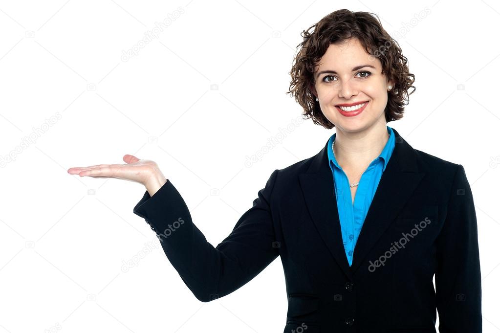 Cheerful business executive presenting copy space area