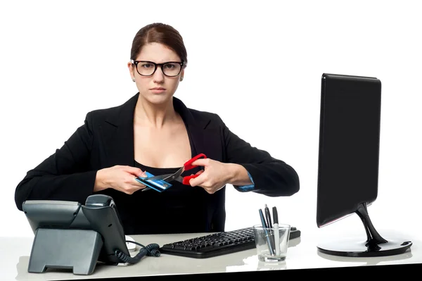 Serious faced woman cutting her credit card — Stok fotoğraf