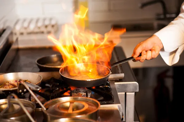 Chef cooking in kitchen stove — Stock Photo, Image