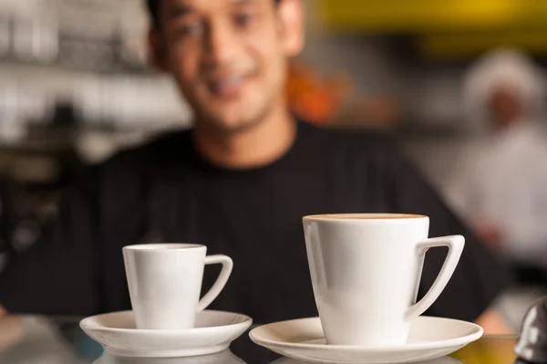 Coffee for you, restaurant staff in background — Stock Photo, Image