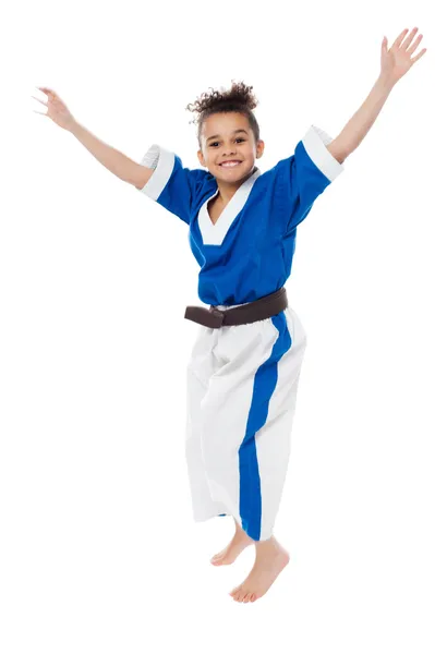 Enthusiastic young girl kid in karate uniform — Stock Photo, Image
