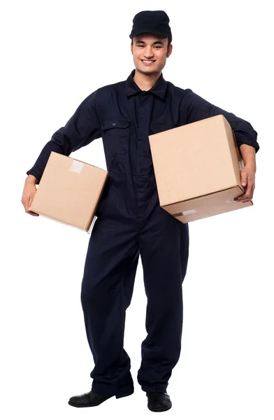 Young courier boy holding parcels — Stock Photo, Image
