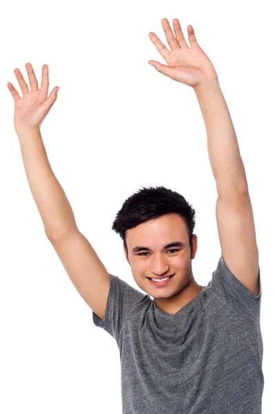 Cheerful young guy raising his arms — Stock Photo, Image