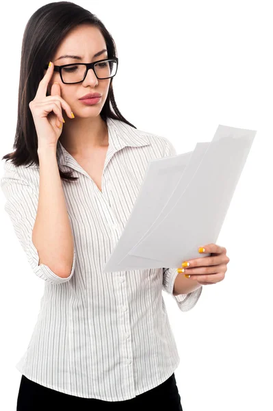 Female analyzing annual business reports — Stock Photo, Image