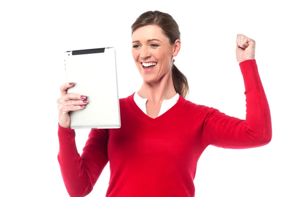 Excited pretty woman holding touch pad — Stock Photo, Image