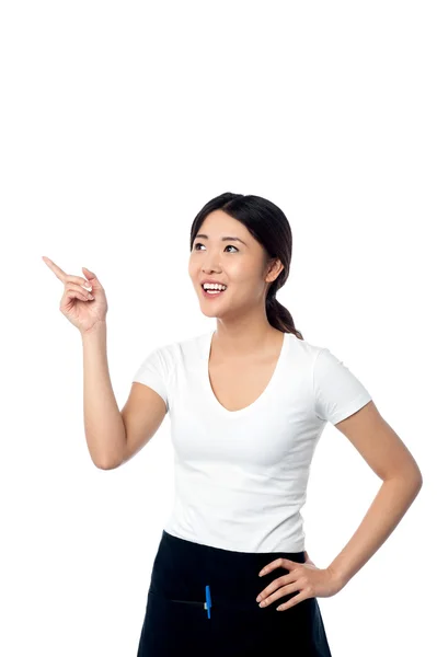 Young woman pointing and looking away — Stock Photo, Image