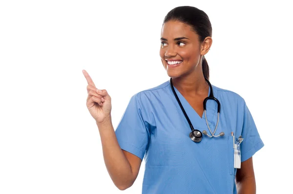 Female physician pointing and looking away — Stock Photo, Image