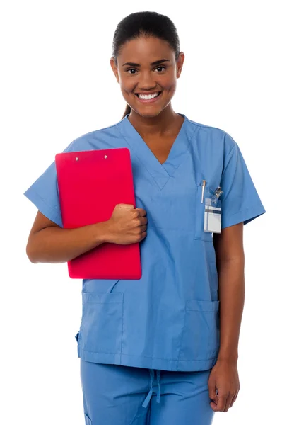 Active female nurse holding clipboard, at duty — Stock Photo, Image