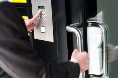 Man entering security code to unlock the door clipart