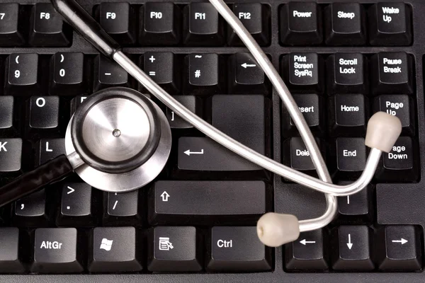 Stethoscope on a computer keyboard — Stock Photo, Image