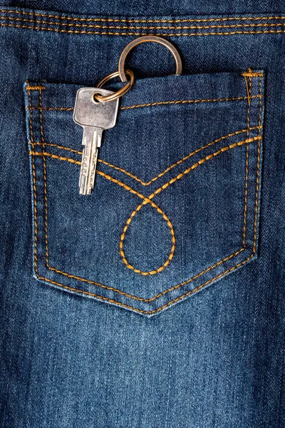Key hanging out of back pocket of a jeans — Stock Photo, Image