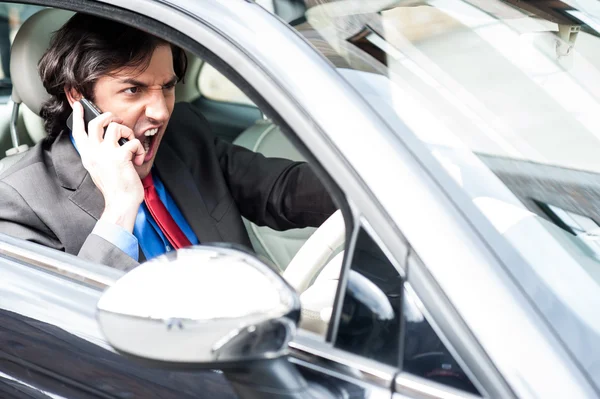 Arg affärsman skriker under körning — Stockfoto