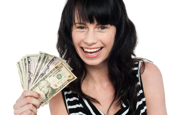 Attractive young girl holding currency fan — Stock Photo, Image