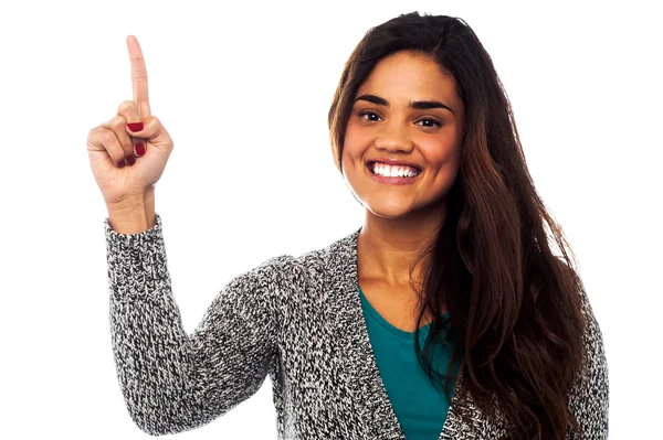 Casual smiling girl pointing upwards — Stock Photo, Image