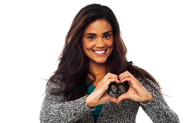 Pretty woman making heart symbol with hands — Stock Photo, Image