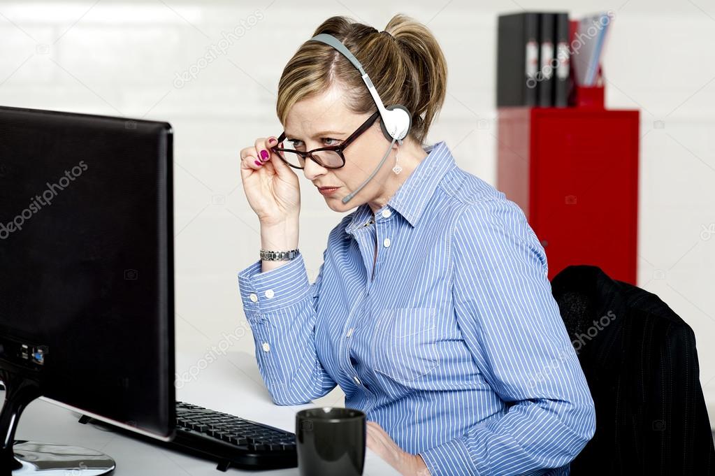 Business lady reviewing report closely