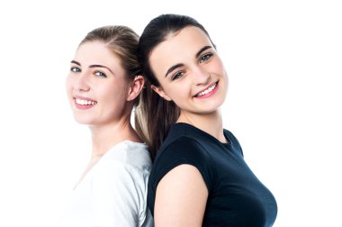 Happy teen girls standing back to back clipart