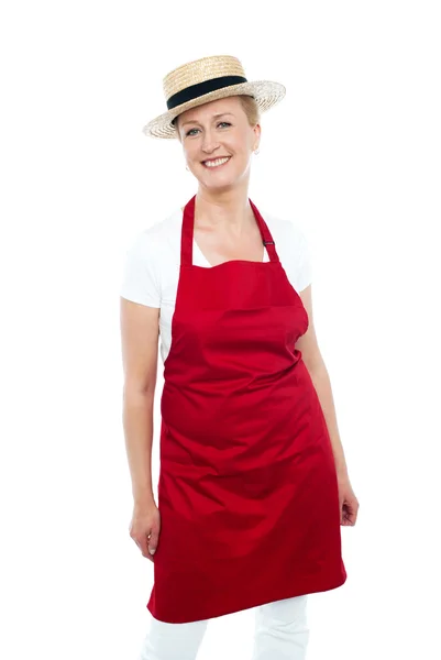 Attractive female chef wearing red apron and hat — Stock Photo, Image