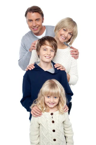 Family of four posing in a row — Stock Photo, Image