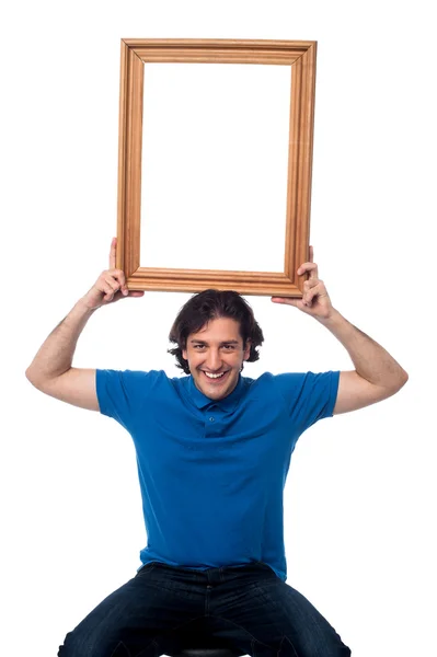 Smiling guy holding onto memories — Stock Photo, Image