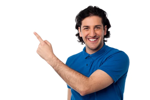 Handsome young male pointing at something — Stock Photo, Image