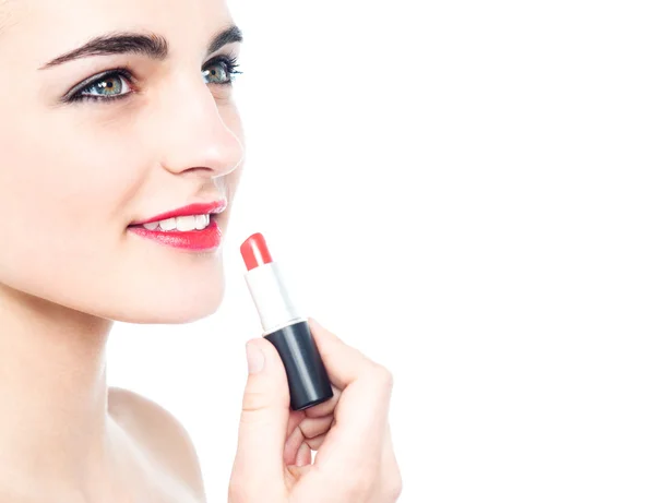 Cheerful teen girl applying red lipstick — Stock Photo, Image