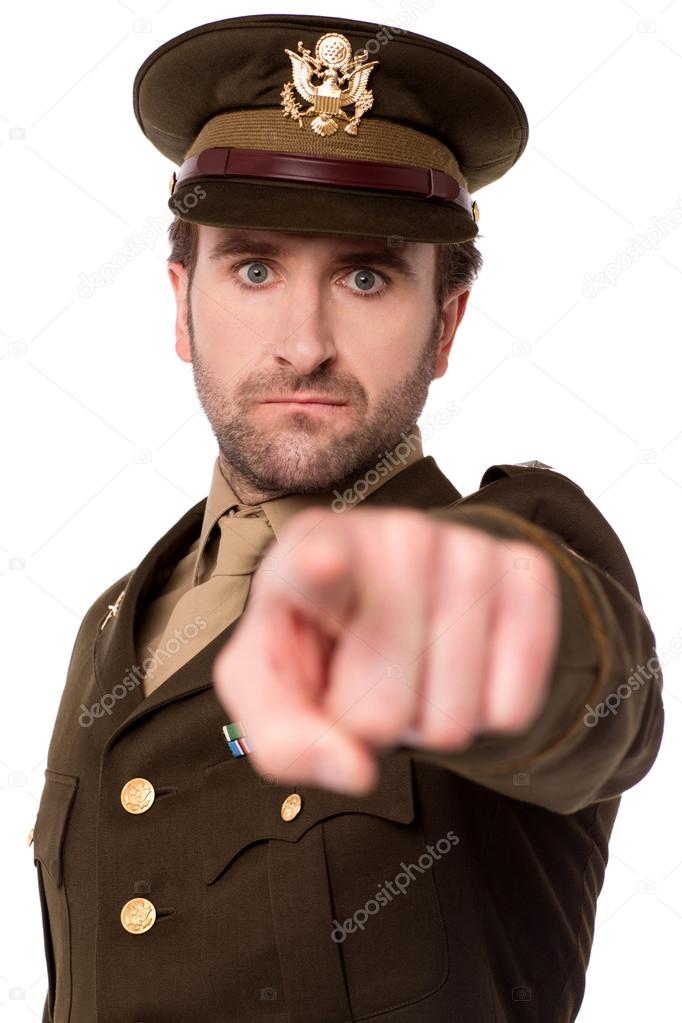 Young soldier pointing towards camera