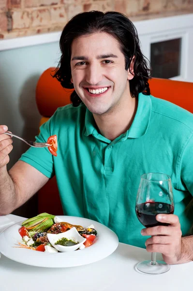 Knappe jonge kerel genieten van zijn maaltijd — Stockfoto