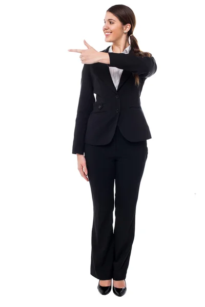 Corporate lady pointing at something — Stock Photo, Image