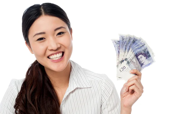 Pretty woman holding a fan of currency notes — Stock Photo, Image