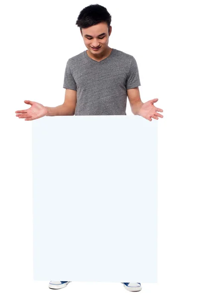 Handsome guy behind blank ad board — Stock Photo, Image
