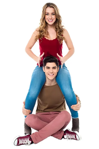 Gorgeous girl sitting on her boyfriend's shoulder — Stock Photo, Image