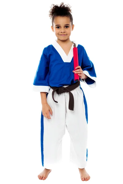 Karate girl holding nunchucks — Stock Photo, Image