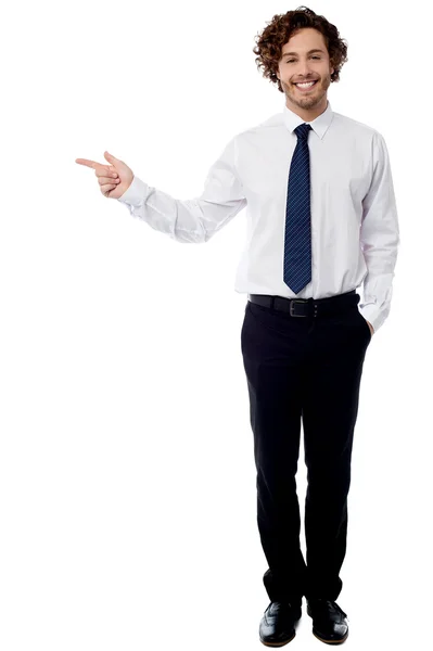 Smart business executive pointing away — Stock Photo, Image