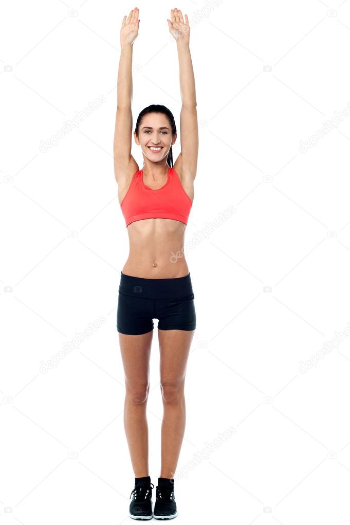 Fitness enthusiast stretching her arms